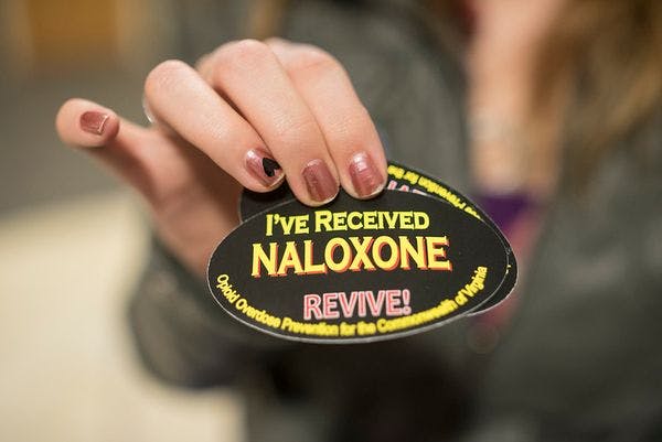 What is naloxone, and how does it reverse opioid overdoses?